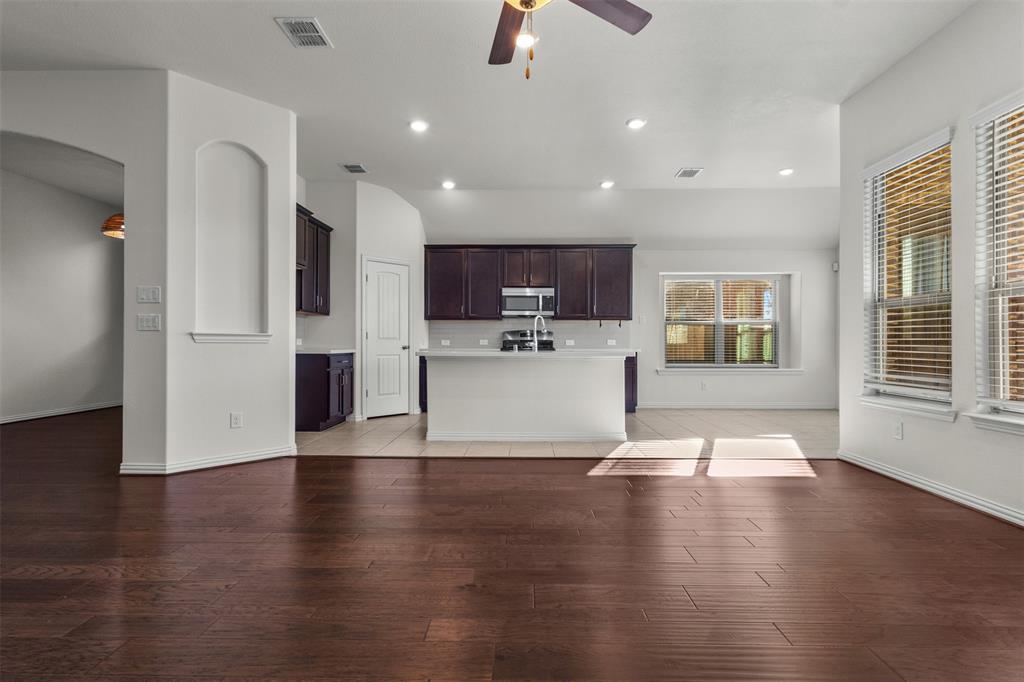 1740 Rio Costilla Road Fort Worth, TX 76131 - Photo 10 of 40 Open concept living space featuring recessed lighting, dark wood-finish flooring, a ceiling fan, and large windows with blinds