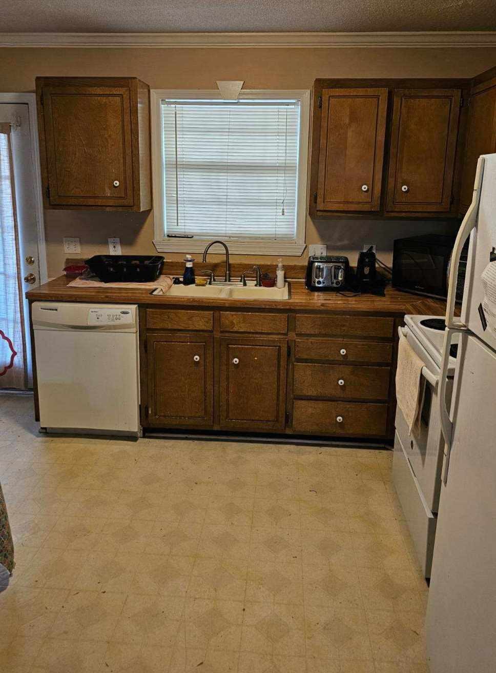 3004 Towne Valley Road Antioch, TN 37013 - Photo 4 of 6 a kitchen with granite countertop a sink and a stove top oven