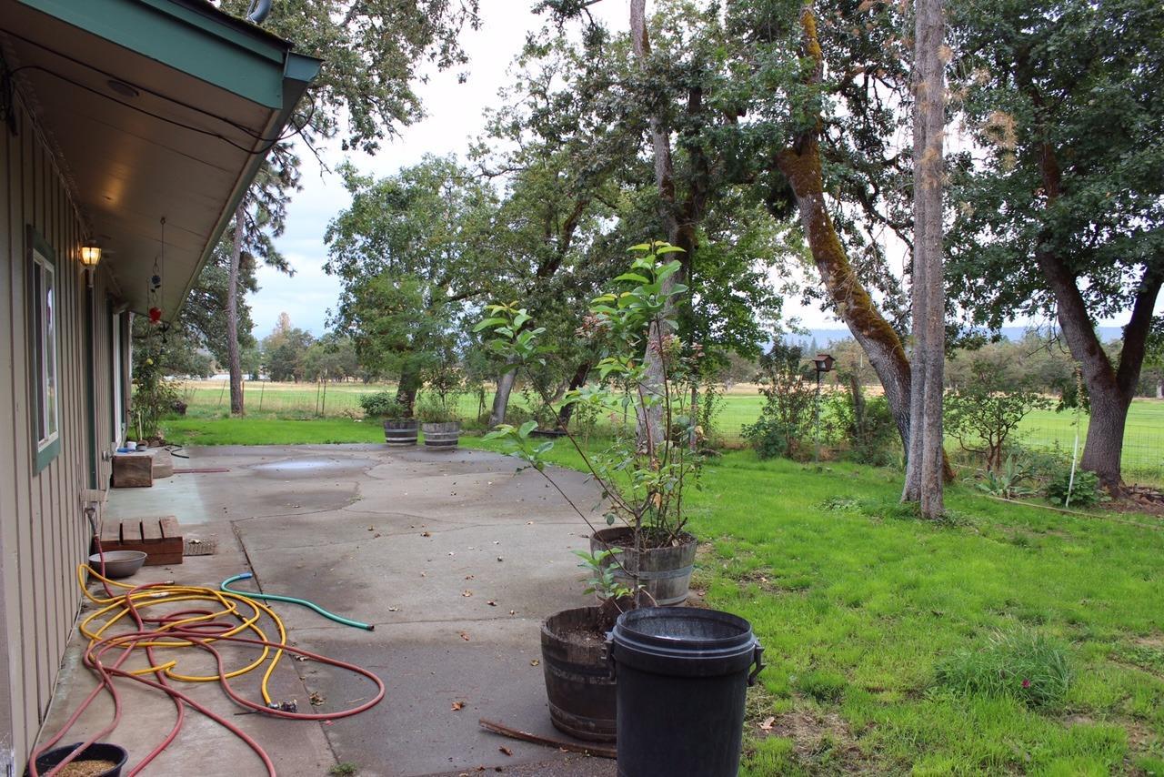 14841 Agate Road Eagle Point, OR 97524 - Photo 8 of 25 a view of a backyard with table and chairs and a fire pit