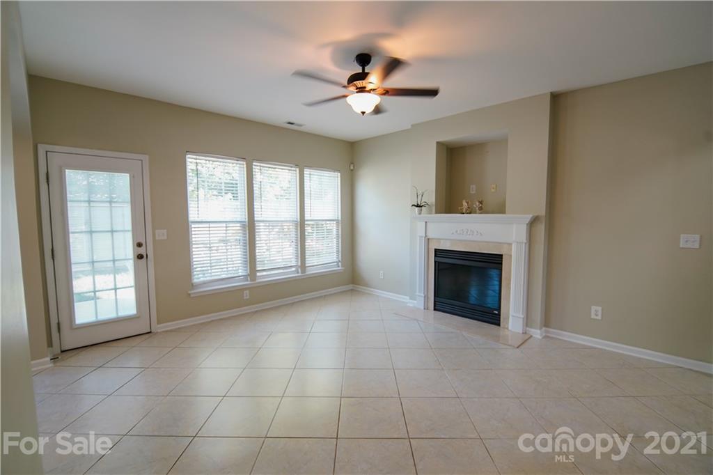 2318 Mirage Place Fort Mill, SC 29708 - Photo 11 of 27 a view of an empty room with a fireplace and a window