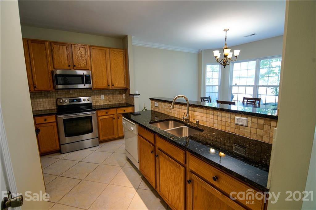 2318 Mirage Place Fort Mill, SC 29708 - Photo 13 of 27 a kitchen with stainless steel appliances a sink a stove and cabinets