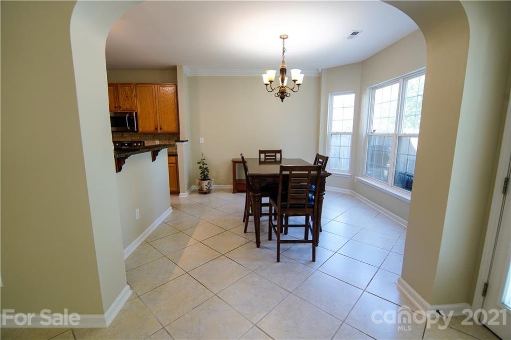 2318 Mirage Place Fort Mill, SC 29708 - Photo 14 of 27 a view of a dining room with furniture and a chandelier