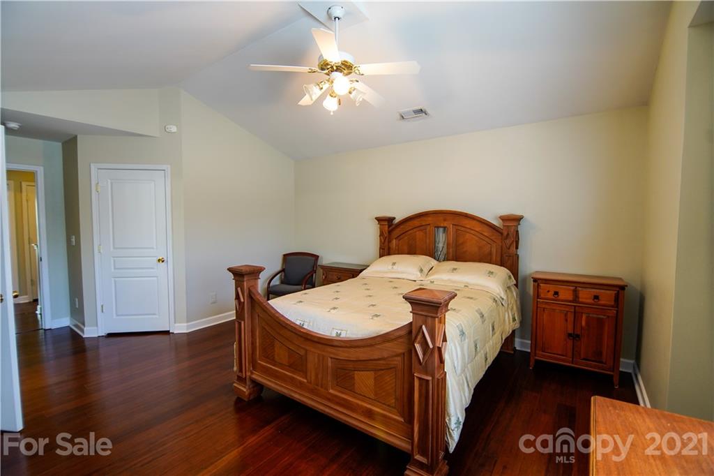 2318 Mirage Place Fort Mill, SC 29708 - Photo 16 of 27 a bedroom with a bed and wooden floor