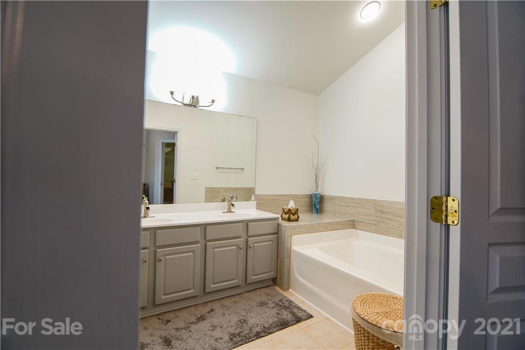 2318 Mirage Place Fort Mill, SC 29708 - Photo 17 of 27 a bathroom with a tub sink and mirror