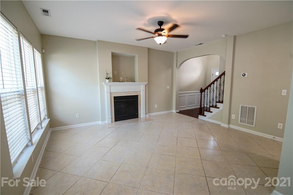 2318 Mirage Place Fort Mill, SC 29708 - Photo 10 of 27 a view of an empty room with a fireplace and a window