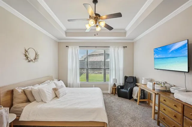 a spacious bedroom with a bed and a chandelier
