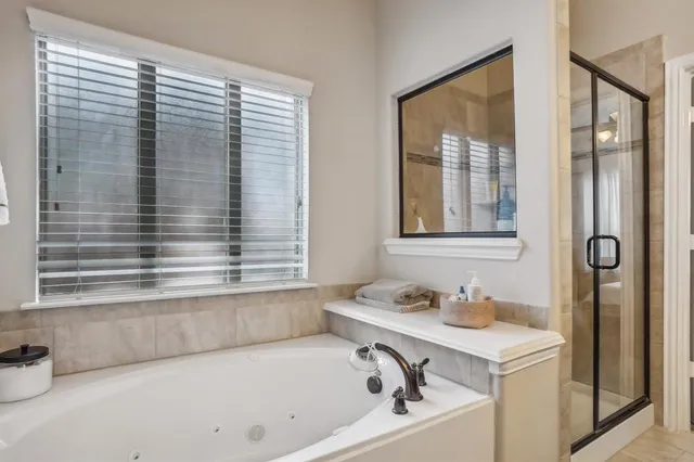 a bathroom with a bathtub and a shower