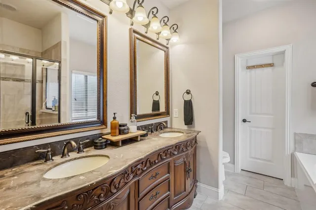 a bedroom with a bed a dresser and a window