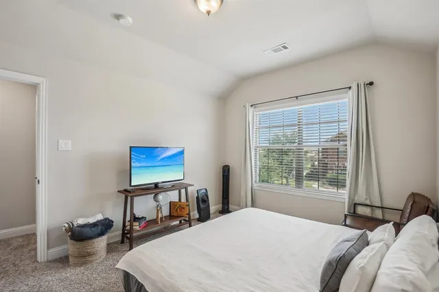 a bedroom with bed and a window