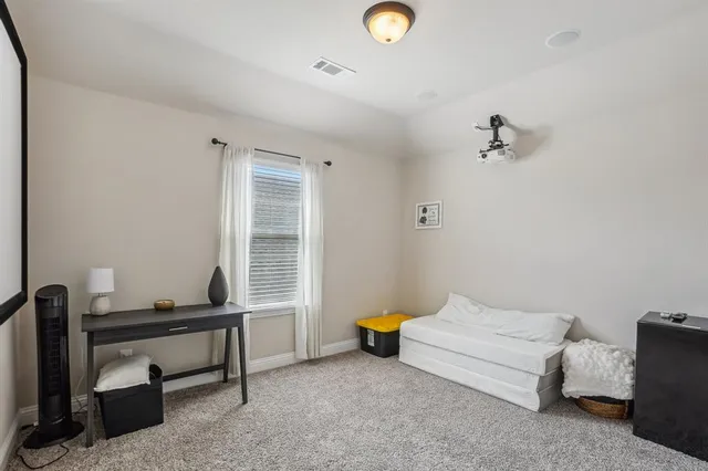 a spacious bedroom with a bed and a window