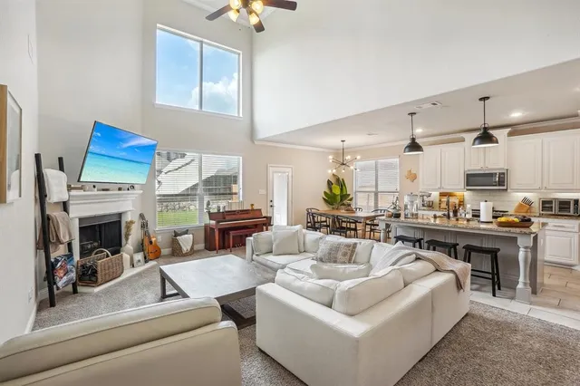 a living room with furniture a window and a fireplace