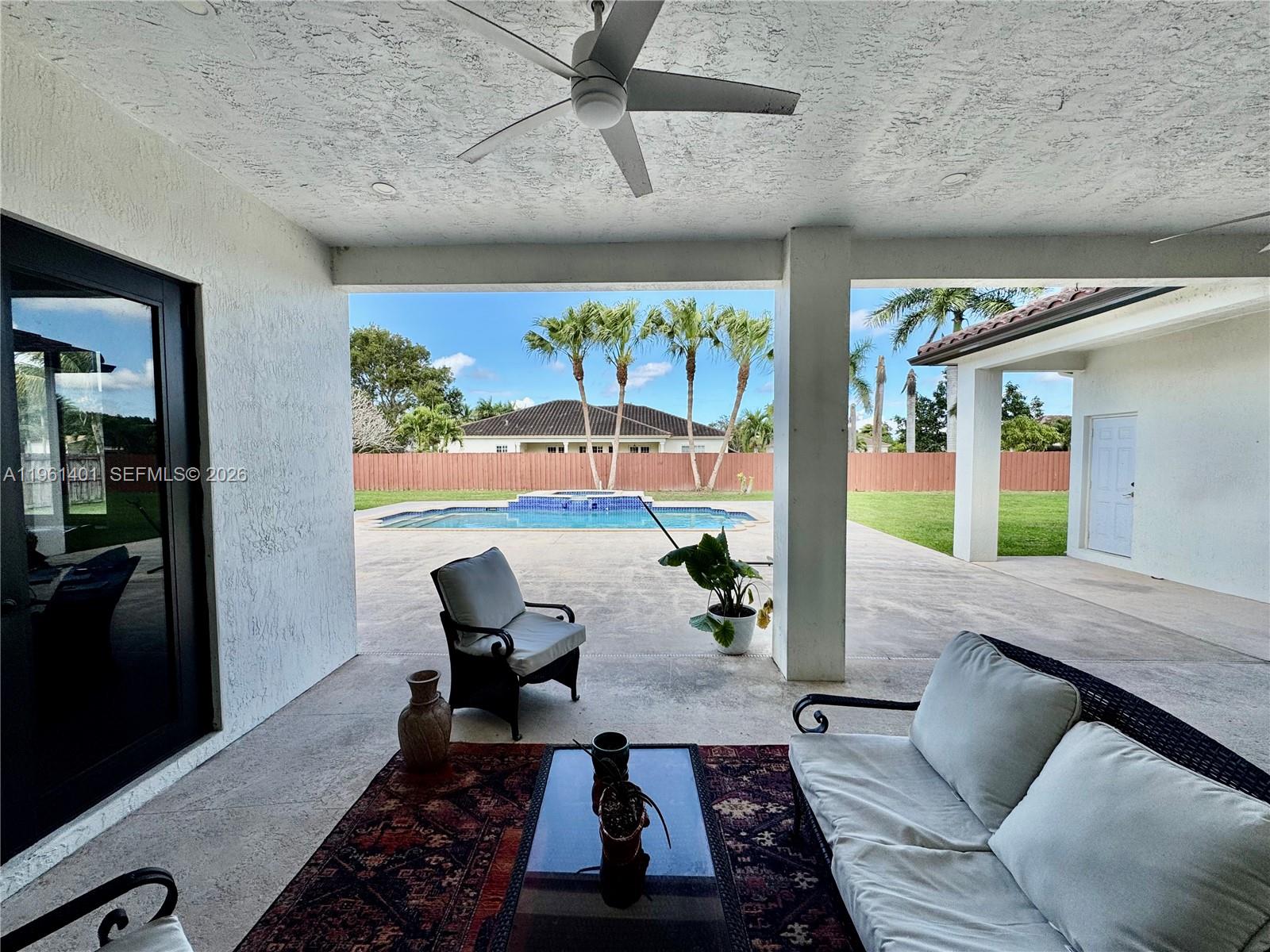 20449 Southwest 328th Street Homestead, FL 33030 - Photo 13 of 34 a living room with furniture and a rug