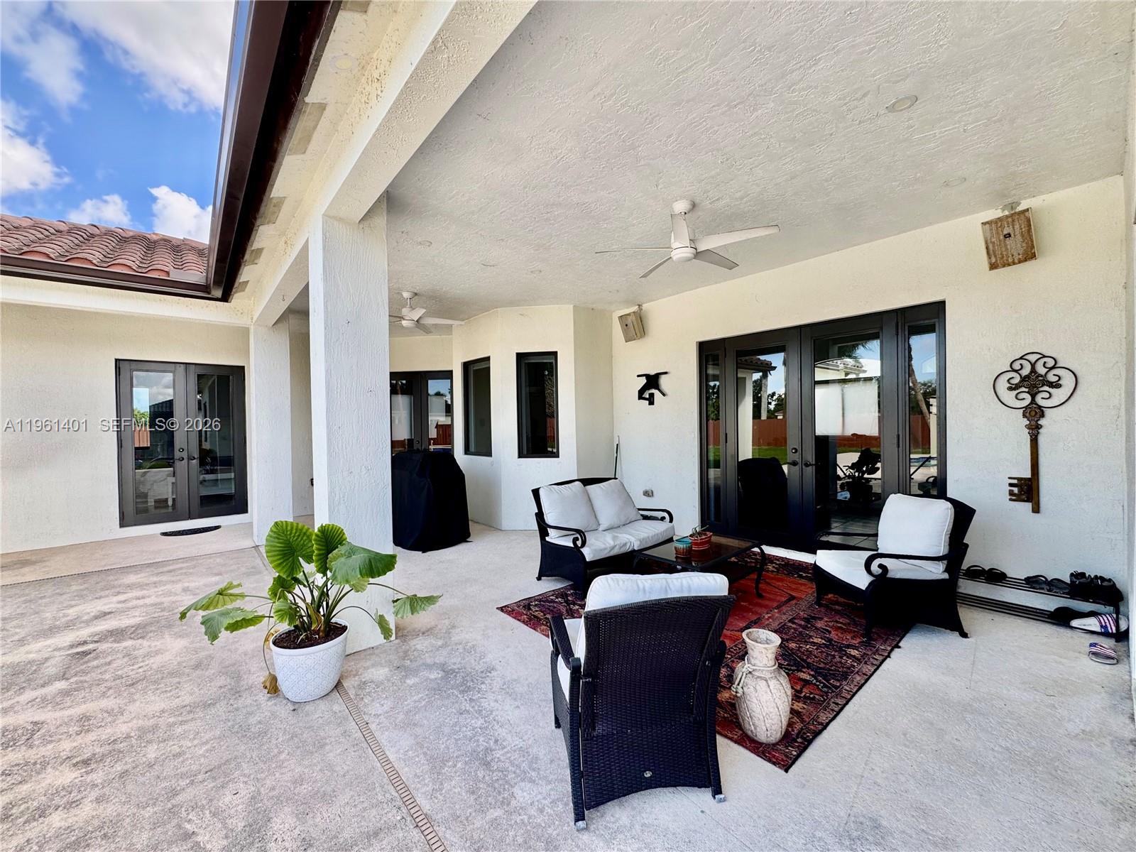 20449 Southwest 328th Street Homestead, FL 33030 - Photo 14 of 34 a living room with furniture flowerpot and wooden floor