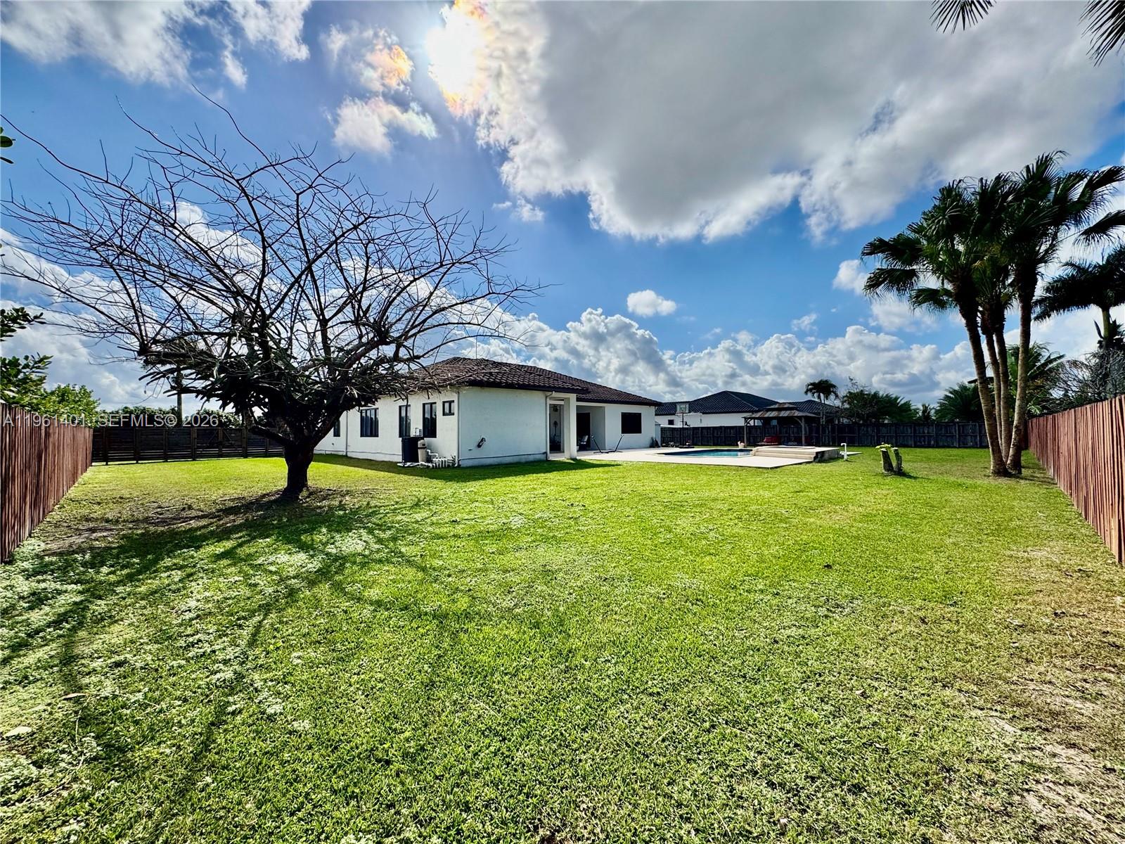 20449 Southwest 328th Street Homestead, FL 33030 - Photo 15 of 34 a front view of house with yard and green space