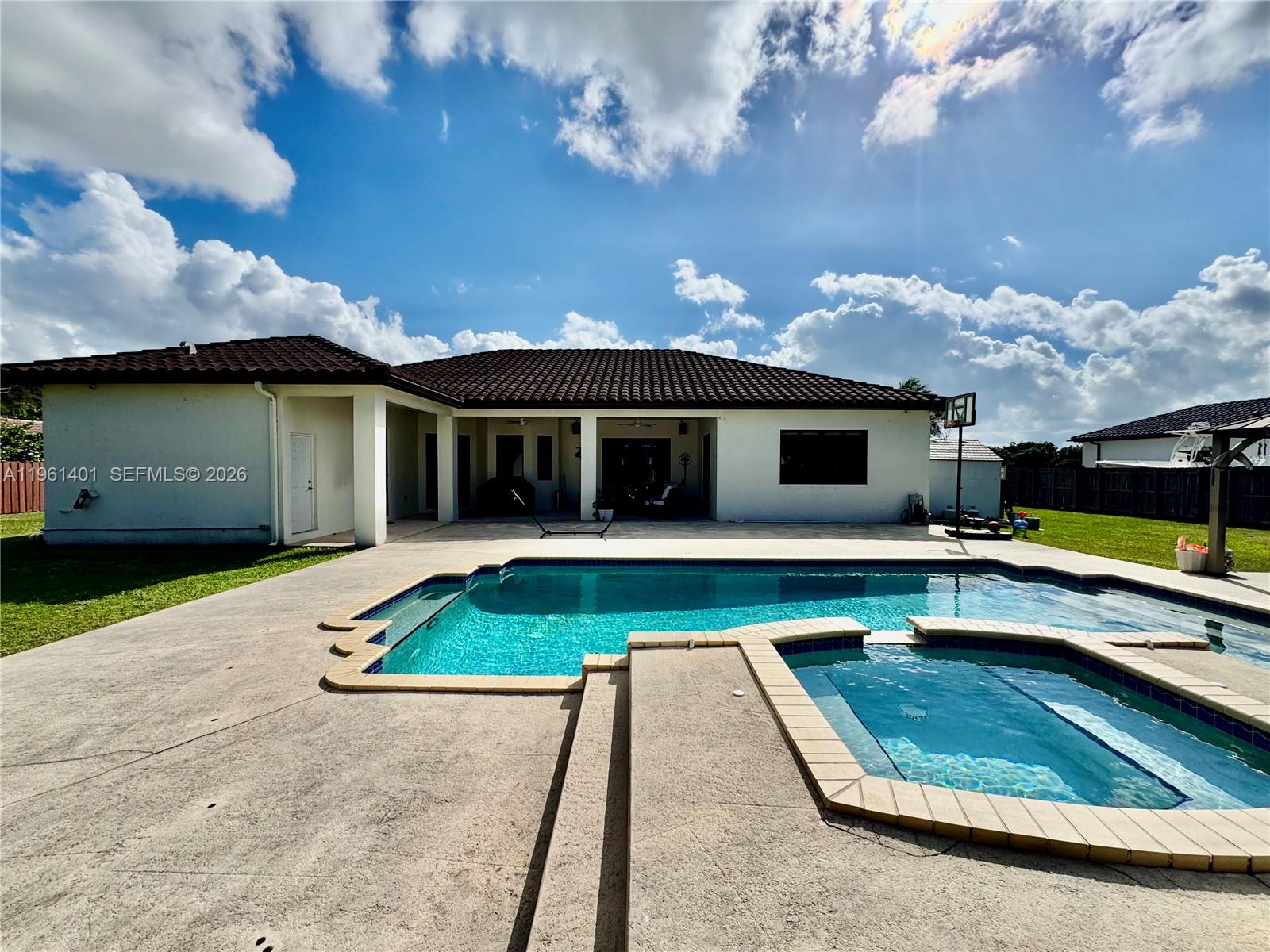 20449 Southwest 328th Street Homestead, FL 33030 - Photo 16 of 34 a view of a house with swimming pool