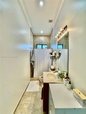 a bathroom with a sink mirror and a shower