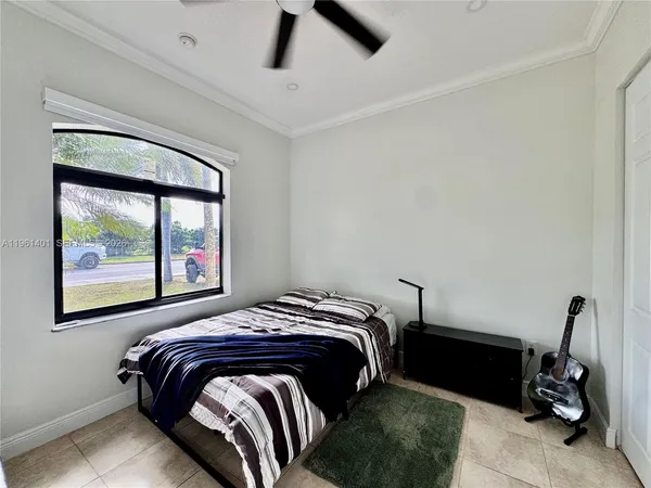 a bedroom with a bed and a painting on the wall