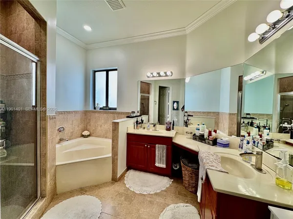 a bathroom with a tub sink and mirror
