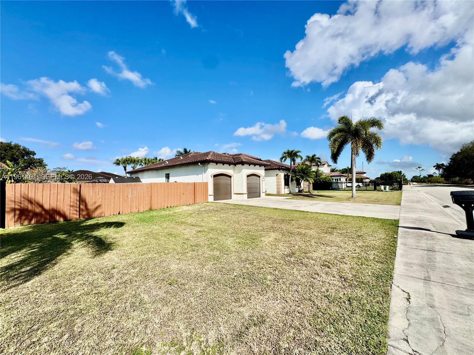 20449 Southwest 328th Street Homestead, FL 33030 - Photo 4 of 34 a front view of a house with a yard