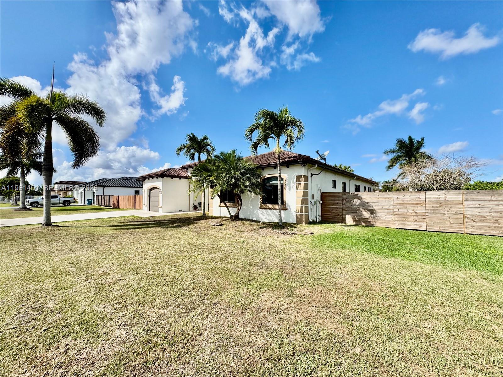 20449 Southwest 328th Street Homestead, FL 33030 - Photo 5 of 34 a house view with a garden space