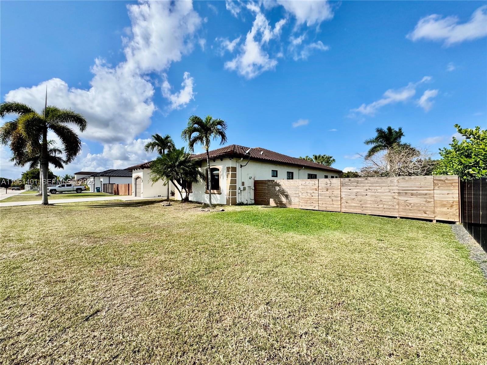 20449 Southwest 328th Street Homestead, FL 33030 - Photo 6 of 34 a view of a house with a backyard