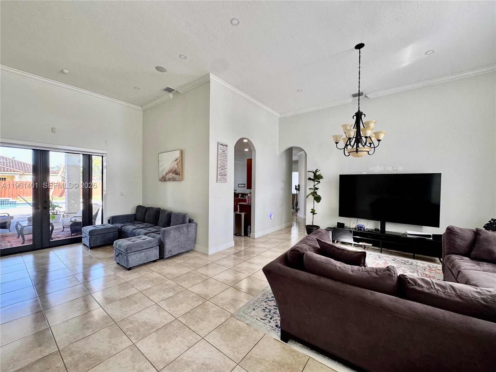 20449 Southwest 328th Street Homestead, FL 33030 - Photo 8 of 34 a living room with furniture and a flat screen tv