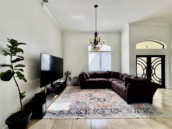 a living room with furniture and a flat screen tv