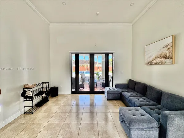 a living room with furniture and a large window