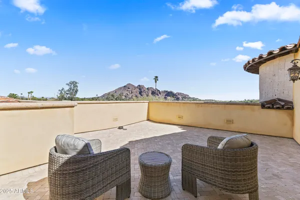 a terrace with outdoor seating and city view