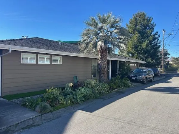 a front view of a house with a garden