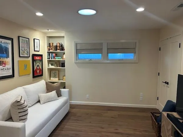 a living room with furniture and painting on the wall