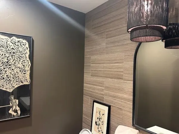 a lamp on a table in a bathroom