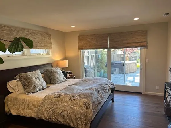 a bedroom with a large bed and a window