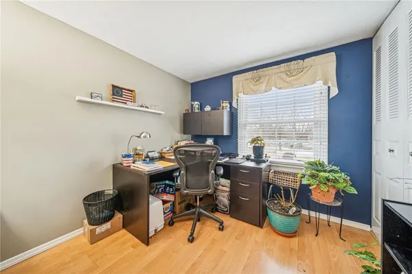 a view of a workspace with furniture and a window