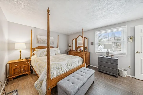 a bedroom with a bed window and a mirror