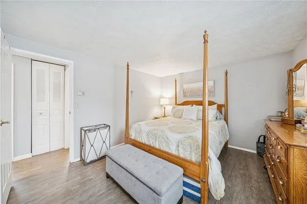 a bed room with a bed and a flat tv screen