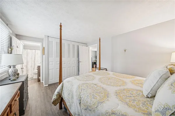 a spacious bedroom with a bed and closet