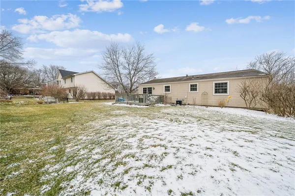 a view of house with backyard and tree