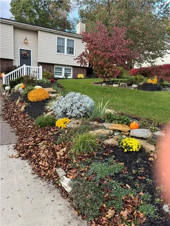 a view of a house with a yard and sitting area