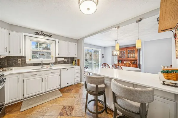 a kitchen with stainless steel appliances granite countertop a sink and cabinets