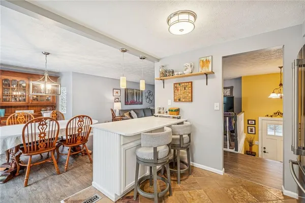 a view of a dining room with furniture and a chandelier