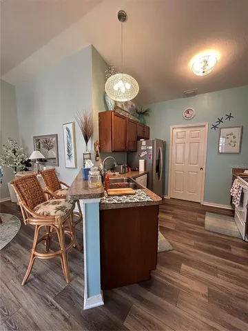 a view of a dining room with furniture wooden floor and a chandelier
