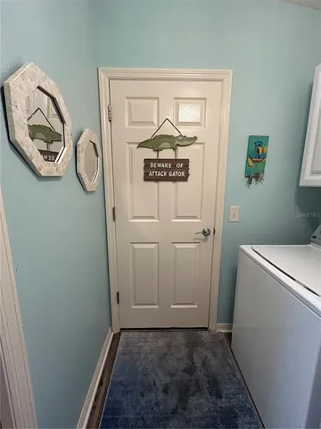 a view of a hallway with washer and dryer
