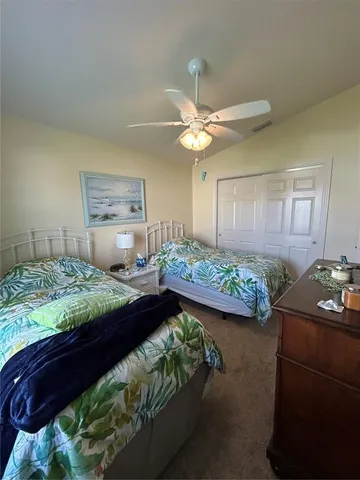 a bedroom with bed and a chandelier