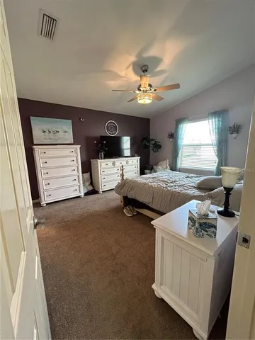 a bed room with furniture and flat screen tv