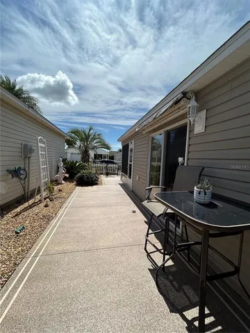 a lobby with table chair and potted plants