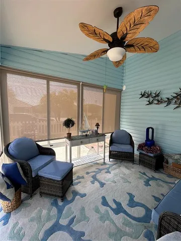 a living room filled with furniture and a large window