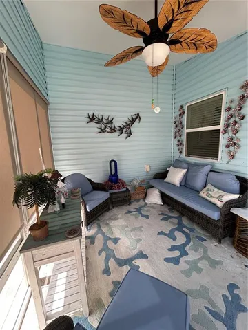 a view of a patio with chairs and potted plants