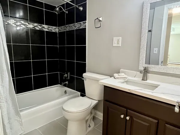 a bathroom with a sink toilet vanity and shower