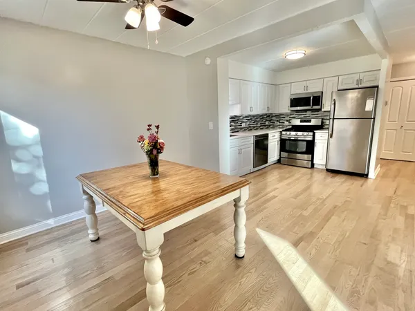 a kitchen with stainless steel appliances kitchen island a refrigerator sink and cabinets